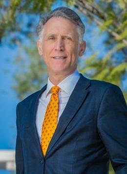 A photo of Pitzer College's seventh President, Strom C. Thacker with McConnell Center in the background.